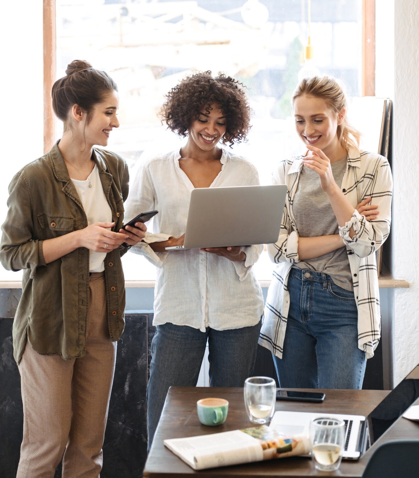Group of cheerful young women studying together