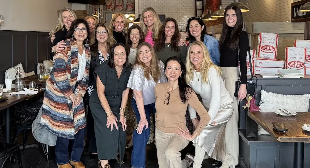 A group of women gathered together at a restaurant